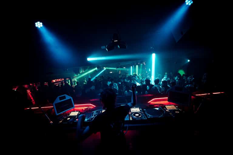 DJ booth facing the Carousel dancefloor under blue and red lights