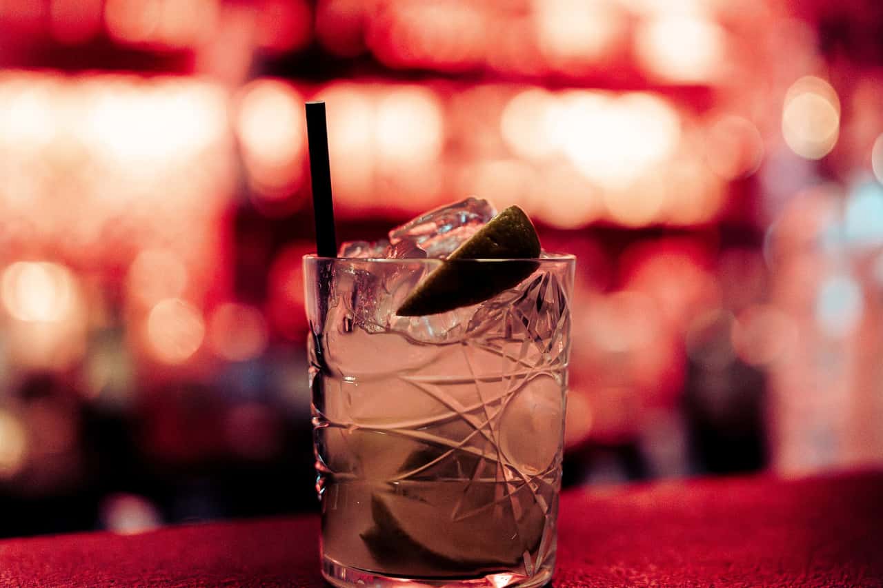 Cocktail on the Carousel bar in front of red back-bar lights